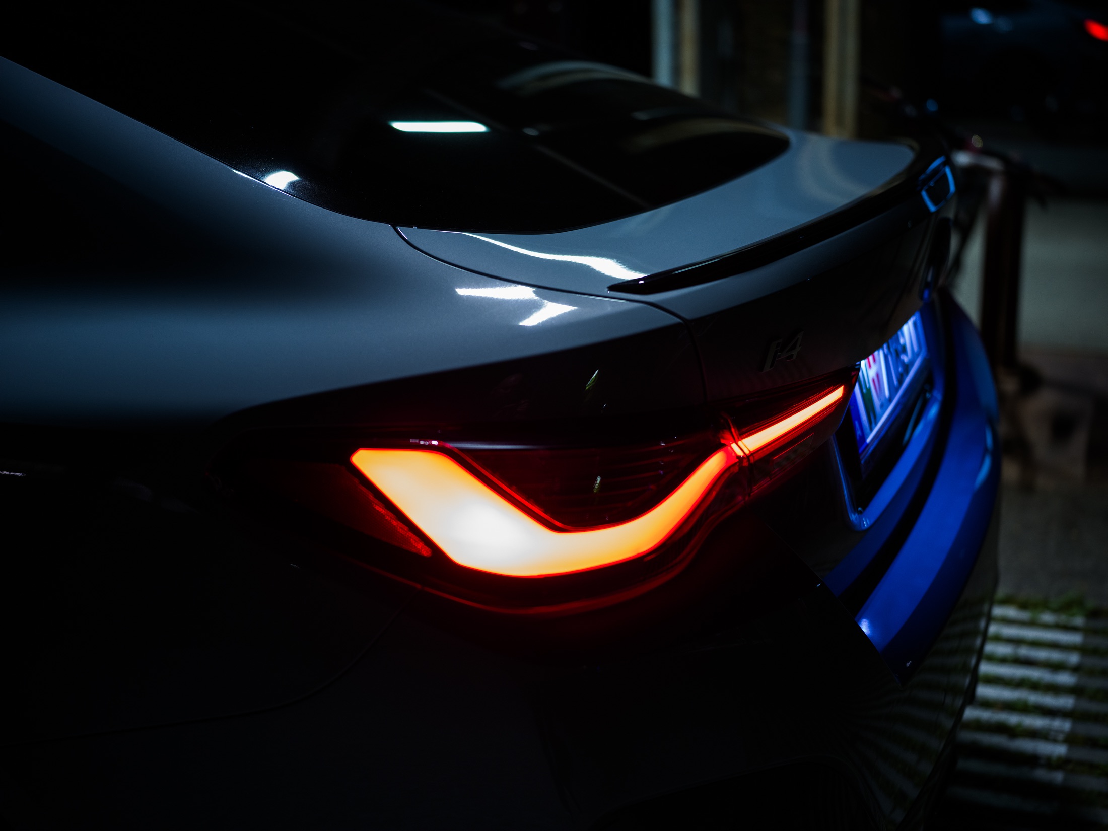 BMW i4 rear light and sculpted bodywork at night